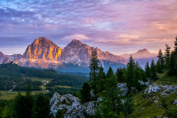 Wall Mural - Panoramic view of famous Dolomites mountain peaks glowing in beautiful golden evening light at sunset in summer, South Tyrol, Italy. Artistic picture. Beauty of mountains world