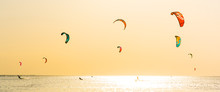 Kite-surfing And A Lot Of Silhouettes Of Kites In The Sky. Holidays On Nature. Artistic Picture. Beauty World. Panorama
