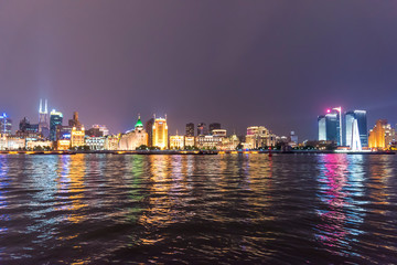 The bund of Shanghai huangpu river of tall buildings in the evening.