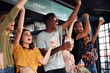 © Monkey Business - Group Of Male And Female Friends Celebrating Whilst Watching Game On Screen In Sports Bar