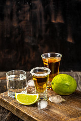 Alcoholic drink concept. Mexican tequila with lime and salt on rustic wood background. space for text. concept luxury drink