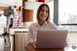 © Milana - Beautiful  young woman is working on her lap top in the coffee shop