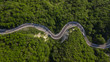 Aerial top down view: of cars driving on zig zag winding mountain road