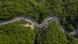 Aerial top view: of cars driving on zig zag winding mountain road