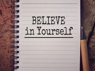 Wall Mural - Motivational and inspirational wording - Believe In Yourself written on a notepad.