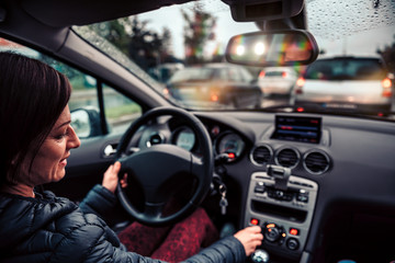 Woman stuck in a traffic jam listening radio