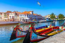 Traditional Boats On The Canal In Aveiro, Portugal. Colorful Moliceiro Boat Rides In Aveiro Are Popular With Tourists To Enjoy Views Of The Charming Canals. Aveiro, Portugal.