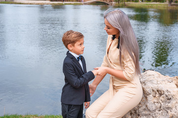 Wall Mural - mother and son walk in the Park by the lake