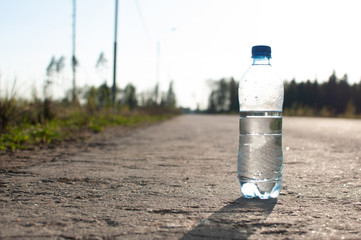 a bottle of water on an empty road