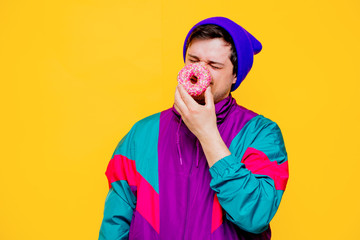 Wall Mural - Funny style white man in 90s jacket and hat with donut on yellow background