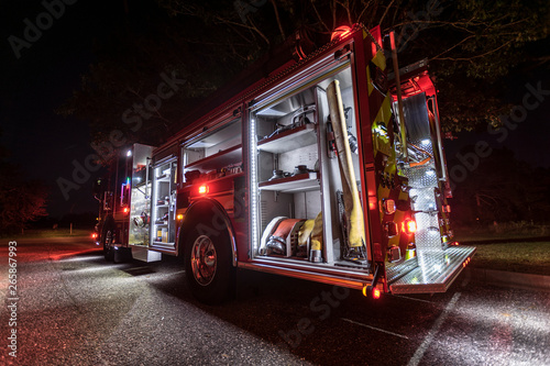 Fire truck glowing in the dark with all lights on. Tableau sur Toile