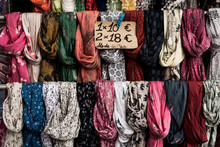 Close Up Of A Large Selection Of Colourful Scarves At A Market Stall.