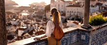 Female Tourist Looking At Old Town From Balcony