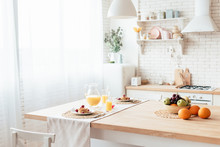 Served Table With Pancakes, Fruits And Orange Juice In Kitchen