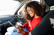 © Westend61 - Happy young woman using tablet in a car