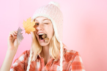 Wall Mural - Surprise woman playing with leaves and looking at camera. Girl in autumn are getting ready for autumn sale. Girl in autumn playing with leaves on autumn leaves background.