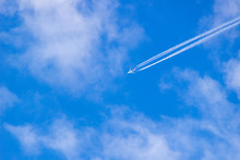 Airplane Contrail Against Blue Sky With Copy Space
