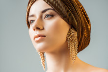 Young Naked Woman With Shiny Makeup, Golden Rings In Turban Looking Away Isolated On Grey