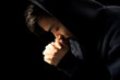 © christianchan - Praying Man Against Dark Background With Copy Space