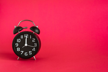 alarm clock on pink background.free space for text