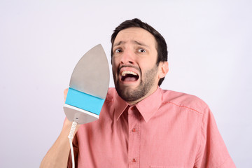 Wall Mural - Young funny man with an iron.