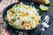 Traditional cole slaw salad in a black bowl