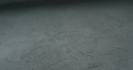 Sticker - Slow motion shot of decorative dark concrete surface, shot handheld