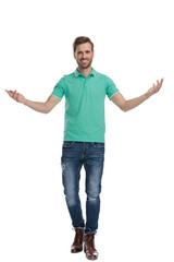 Wall Mural - man in green polo shirt welcomes with hands