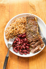 Wall Mural - Braised beef steak in red wine with beans & barley