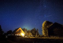Majestic Milky Way And The Shooting Star Above The Village House In Summer. A Starry Night Sky.