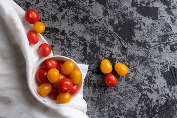 Wall Mural - cherry tomatoes and yellow plum tomatoes on a grunge table, tomato diet ,vegetarian menus