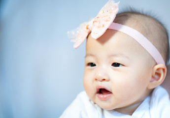 Asian baby happy in the room.Asian baby girl lying down on bed .