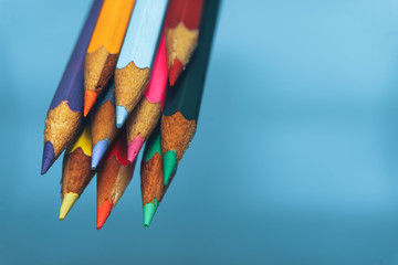 Aufkleber - Beautiful multi-colored pencil in water on a blue background.