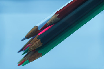 Aufkleber - Beautiful multi-colored pencil in water on a blue background.