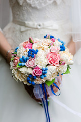 Wall Mural - Beautiful bridal bouquet of peonies and pink roses in the hands of an unrecognizable bride