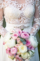 Wall Mural - Unrecognizable bride holding a refined wedding bouquet of pink and white roses with peonies