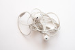 headphones on a white background the wires of the headphones are tangled
