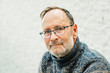 © annanahabed - Outdoor portrait of 50 year old man wearing brown pullover and eyeglasses