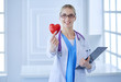 © lenets_tan - Female doctor with the stethoscope holding heart