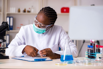 Wall Mural - Young black chemist working in the lab 