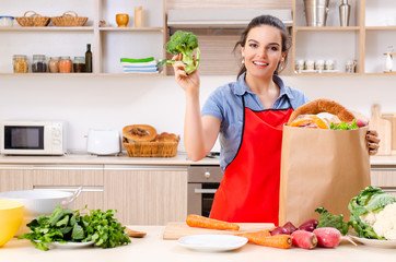 Young woman with vegetables in the kitchen 