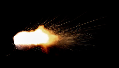 Wall Mural - Texture of firearm shot with bright flash of light, sparks, smoke and gunpowder gases on black background