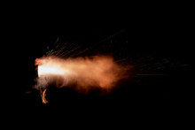 Texture Of Firearm Shot With Bright Flash Of Light, Sparks, Smoke And Gunpowder Gases On Black Background