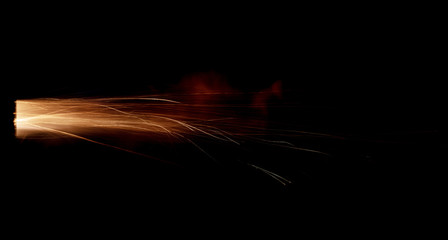 Wall Mural - Texture of firearm shot with bright flash of light, sparks, smoke and gunpowder gases on black background