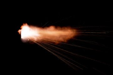 Wall Mural - Texture of firearm shot with bright flash of light, sparks, smoke and gunpowder gases on black background