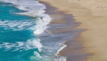 Waves Lapping Onto A Sandy Beach - Image
