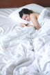 © Space_Cat - Young Woman Sleeping In Bed. Portrait Of Beautiful Female Resting On Comfortable Bed With Pillows In White Bedding Bedroom In Morning.