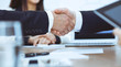 © rogerphoto - Business people shaking hands at meeting or negotiation in the office. Handshake concept. Partners are satisfied because signing contract