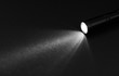 © spaxiax - Flashlight and beam of light on a dark background
