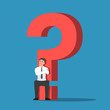 © Jiw Ingka - Businessman sitting on the base of question mark sign